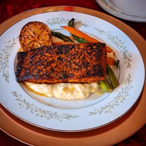 Salmon dinner with vegetables on china plate by Chef Yolanda Lee